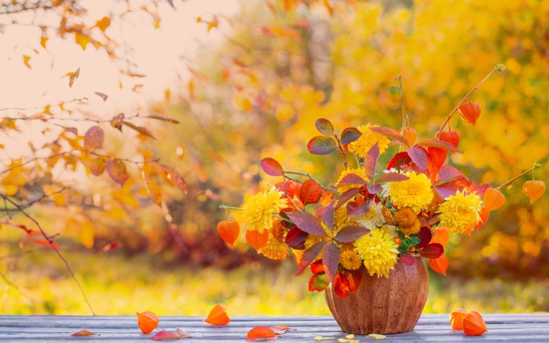 beautiful autumnal  bouquet on wooden table in garden
